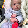 baby, infant, pajamas, blanket, car_seat, face, drool, toy, crochet, flower, hand, soft_texture, clothing, person, portrait, indoor, cute, expression, comfort, child