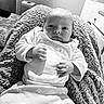 Charika joined the competition — help win amazing prizes! baby, infant, blanket, clothing, face, hand, newborn, person, portrait, soft_texture, monochrome, cozy, cute, lying_down, indoor, sleepwear, expression, young_child, skin, relaxation
