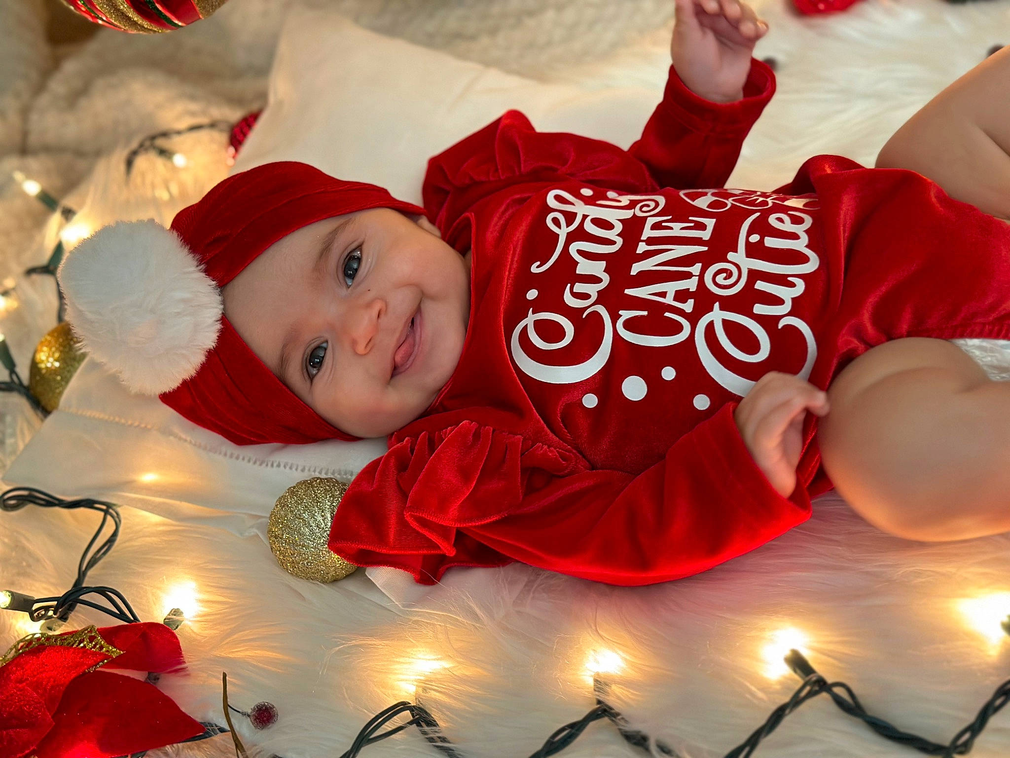 Danna is registered to the contest to win money with this photo: baby, beauty, child, christmas, christmas_decoration, christmas_eve, christmas_ornament, event, font, fun, happy, hat, headwear, holiday, joy, light, lighting, person, photograph, red