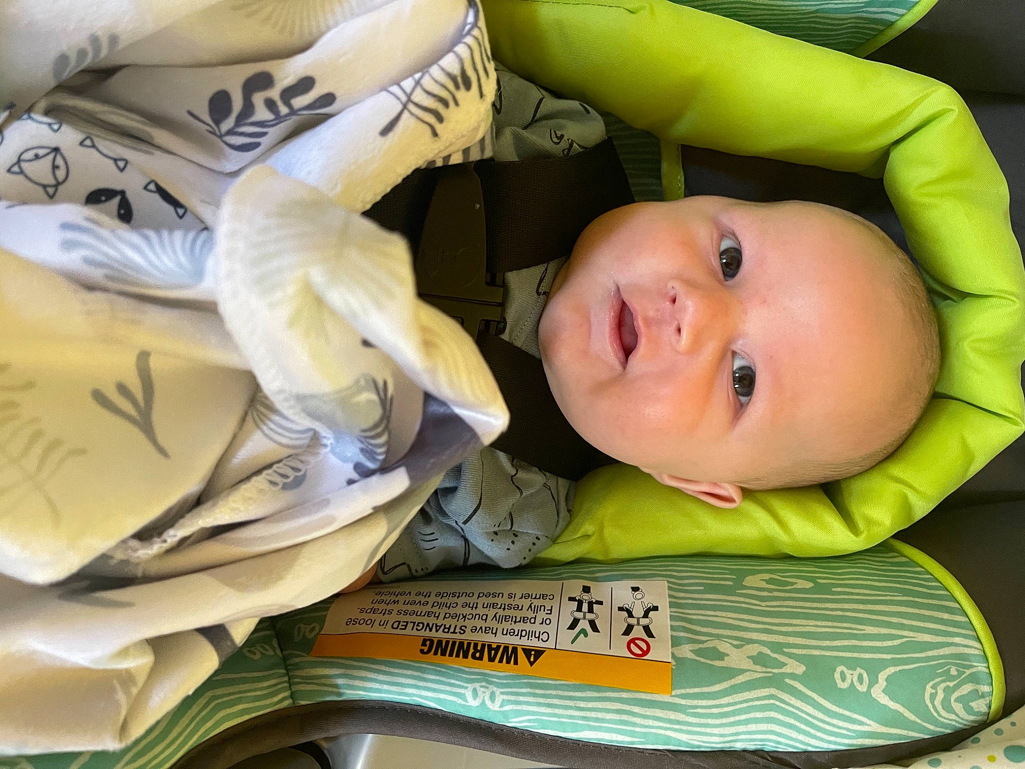 Bo is registered to the contest to win money with this photo: baby, baby_carriage, baby_products, baby_safety, baby_toddler_clothing, cheek, child, comfort, eye, happy, head, linens, person, personal_protective_equipment, publication, room, sitting, smile, toddler, white
