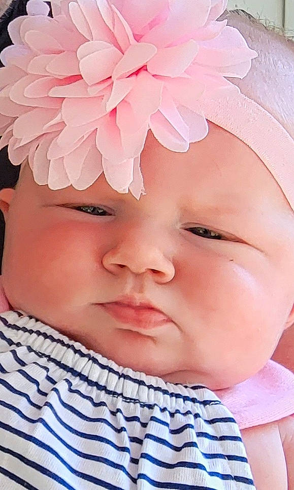Adalynn is registered to the contest to win money with this photo: baby, baby_sleeping, baby_toddler_clothing, cap, child, eyelash, facial_expression, finger, flower, happy, headband, headgear, headpiece, headwear, magenta, person, petal, pink, plant, product