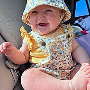 Dixie joined the competition — help win amazing prizes! baby, car_seat, child, clothing, cute, floral, foot, hand, happy, hat, infant, interior, overalls, person, portrait, seatbelt, skin, smile, sunlight, window