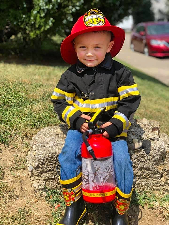 Brentlee joined the competition — help win amazing prizes! baseball_cap, cap, face, footwear, grass, hat, headwear, helmet, jacket, joy, leg, person, personal_protective_equipment, plant, recreation, shoe, smile, sneakers, tire, toddler