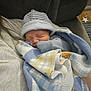 Rhydian is registered to the contest to win money with this photo: baby, newborn, blanket, blue, yellow, hat, sleeping, person, couch, fabric, striped, cozy, indoor, comfort, rest, soft, child, human, bundle, nap