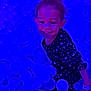 Legacy is registered to the contest to win money with this photo: child, ball_pit, blue_balls, glowing, purple_lighting, smiling, top_knot, heart_pattern, dark_clothing, play, fun, joyful, indoor, wristband, cute, happy, person, young, entertainment, colorful