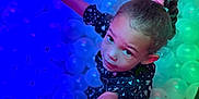 Legacy is registered to the contest to win money with this photo: child, girl, ball_pit, reaching, colorful_lighting, play, curious, young, portrait, indoor, fun, entertainment, toy, happy, person, face, hair_tie, wristband, clothing, expression