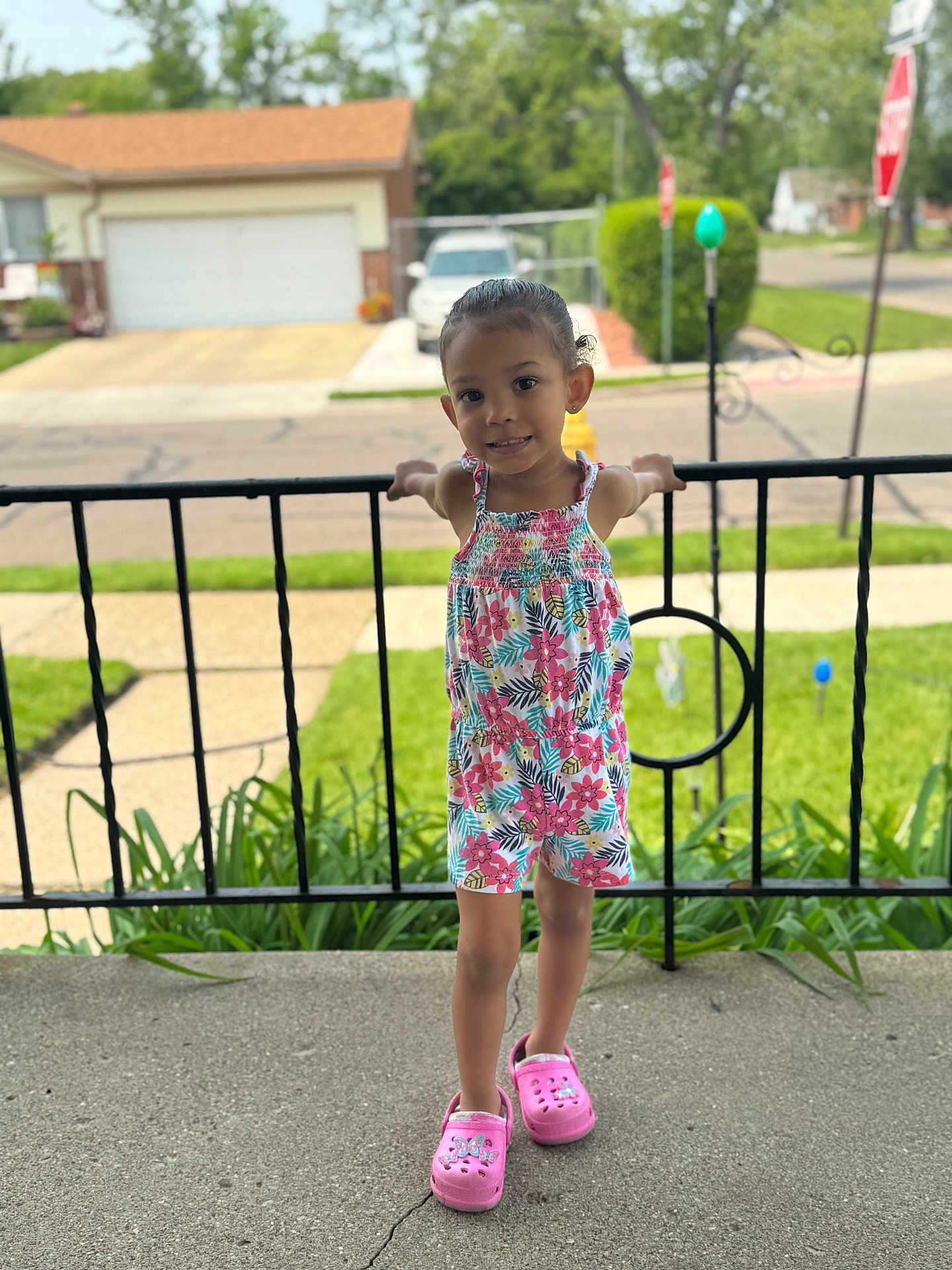 Legacy joined the competition — help win amazing prizes! child, girl, smiling, standing, porch, railing, floral_clothing, pink_shoes, outdoor, daylight, house, sidewalk, grass, street, suburban, earrings, happy, person, casual, summer