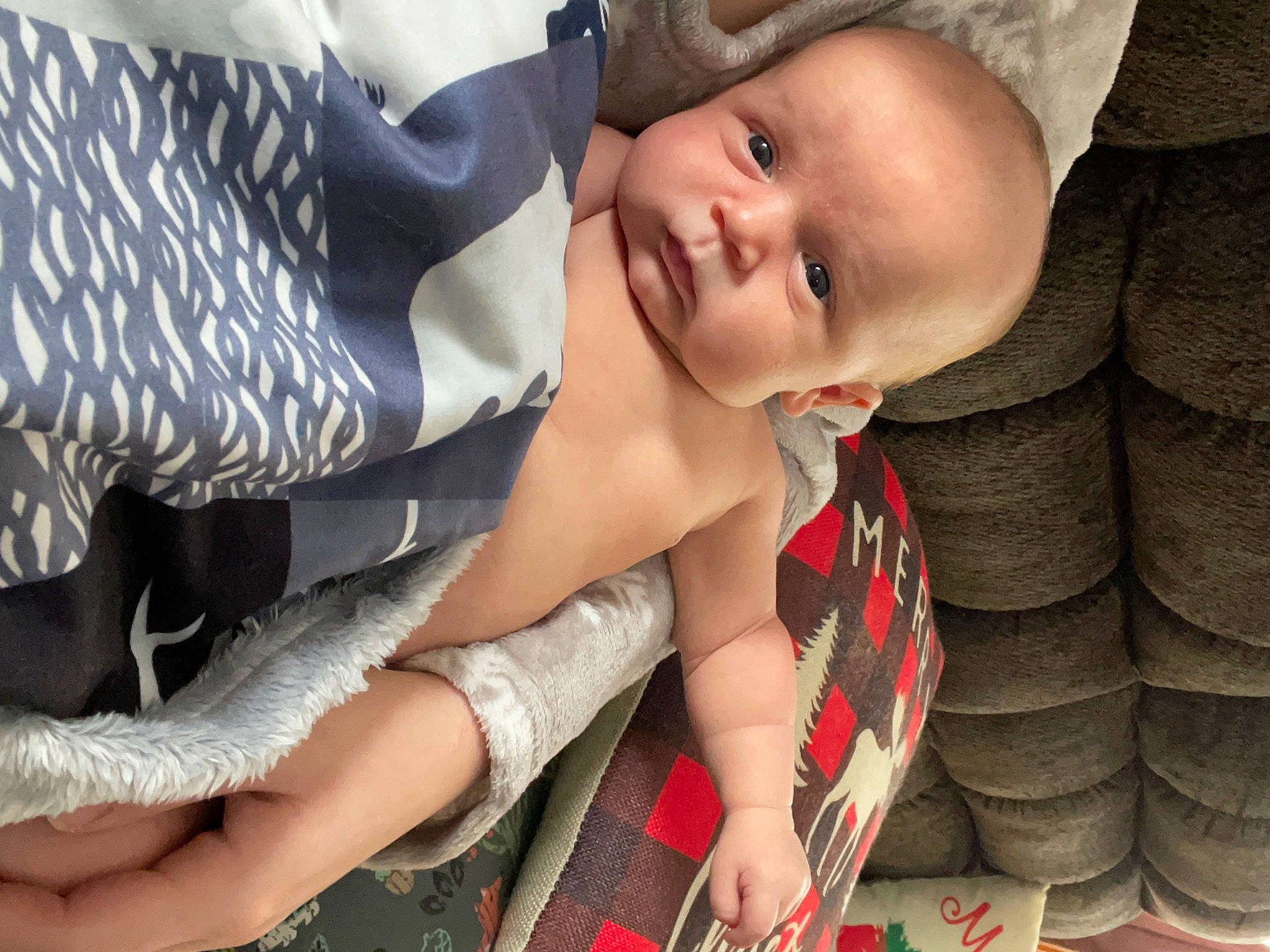 Camden joined the competition — help win amazing prizes! baby, baby_toddler_clothing, cap, child, facial_expression, finger, gesture, grass, happy, hat, human_leg, lap, pattern, person, plaid, skin, smile, sun_hat, textile, thigh