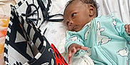 Jacoby is registered to the contest to win money with this photo: baby, infant, onesie, fabric_book, ladybug, bed, blanket, pillow, diapers, baby_supplies, curious, reaching, lying_down, indoor, person, child, cute, soft_toys, colorful, cozy