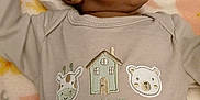 Jacoby is registered to the contest to win money with this photo: baby, blanket, clothing, cozy, cute, embroidery, face, gazing, indoors, infant, lying_down, newborn, outfit, person, portrait, soft, toddler, upward_gaze, warm, young