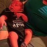 baby, infant, child, face, portrait, sitting, couch, blanket, black_clothing, green_blanket, indoor, home, relaxed, awake, funny_expression, baby_clothing, arms, legs, photographing, camera_interface