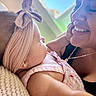 Zoey is registered to the contest to win money with this photo: baby, woman, child, smile, face, headband, pink_dress, earrings, necklace, skin, hand, affection, love, closeup, portrait, indoor, light, blurred_background, happy, tenderness