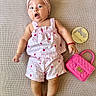 Zoey is registered to the contest to win money with this photo: baby, infant, child, pink, headband, strawberry_pattern, outfit, handbag, blanket, textile, sign, four_months, cute, lying_down, expression, open_mouth, adorable, skin, foot, hand