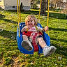 toddler, child, swing, playground, outdoor, grass, bubbles, happy, smiling, sunlight, tree, shoes, blue_swing, red_safety_bar, yellow_rope, backyard, daylight, person, casual_clothing, fun