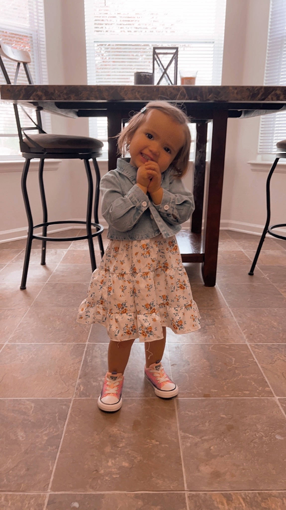 Chloe joined the competition — help win amazing prizes! baby, baby_toddler_clothing, chair, child, door, dress, floor, flooring, footwear, fun, hardwood, human_leg, joy, pattern, person, sandal, shoe, sitting, table, toddler