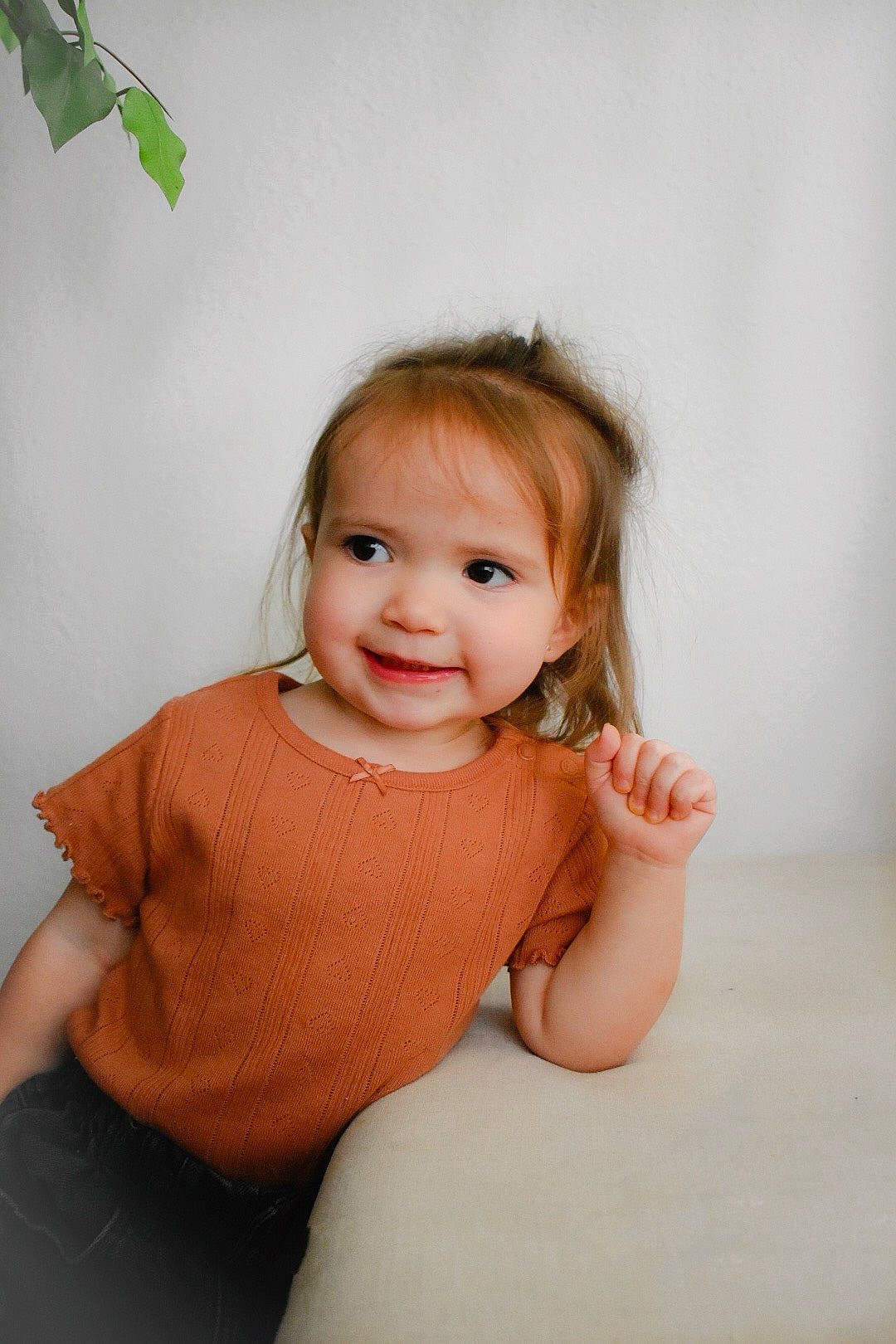Chloe is registered to the contest to win money with this photo: baby_toddler_clothing, brown_hair, cheek, child, dress, elbow, flash_photography, flooring, happy, human_leg, joy, lip, neck, person, shoulder, sitting, skin, sleeve, smile, t_shirt
