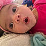Mia joined the competition — help win amazing prizes! baby, closeup, face, headband, pink, flower, expression, surprised, eyes, mouth, towel, blanket, clothing, infant, cute, portrait, skin, person, lying_down, indoors