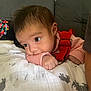 baby, infant, face, arm, red_overalls, striped_shirt, blanket, animal_print, couch, indoor, curious, wide_eyes, resting, soft_texture, closeup, child, person, young, head, hand