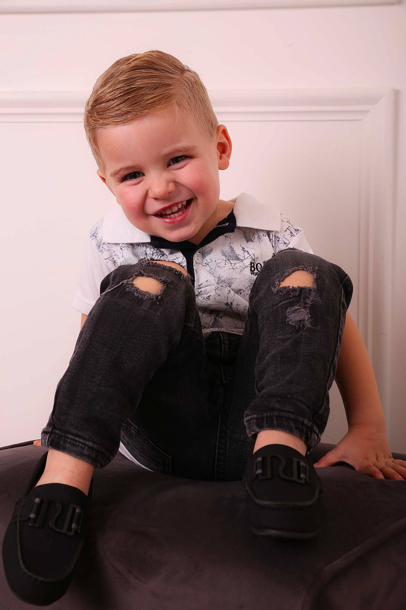 Jenson is registered to the contest to win money with this photo: arm, blond, cheek, child, child_model, footwear, hairstyle, jeans, joint, joy, leg, person, personal_protective_equipment, photo_shoot, photography, shoe, shoulder, sitting, sleeve, standing