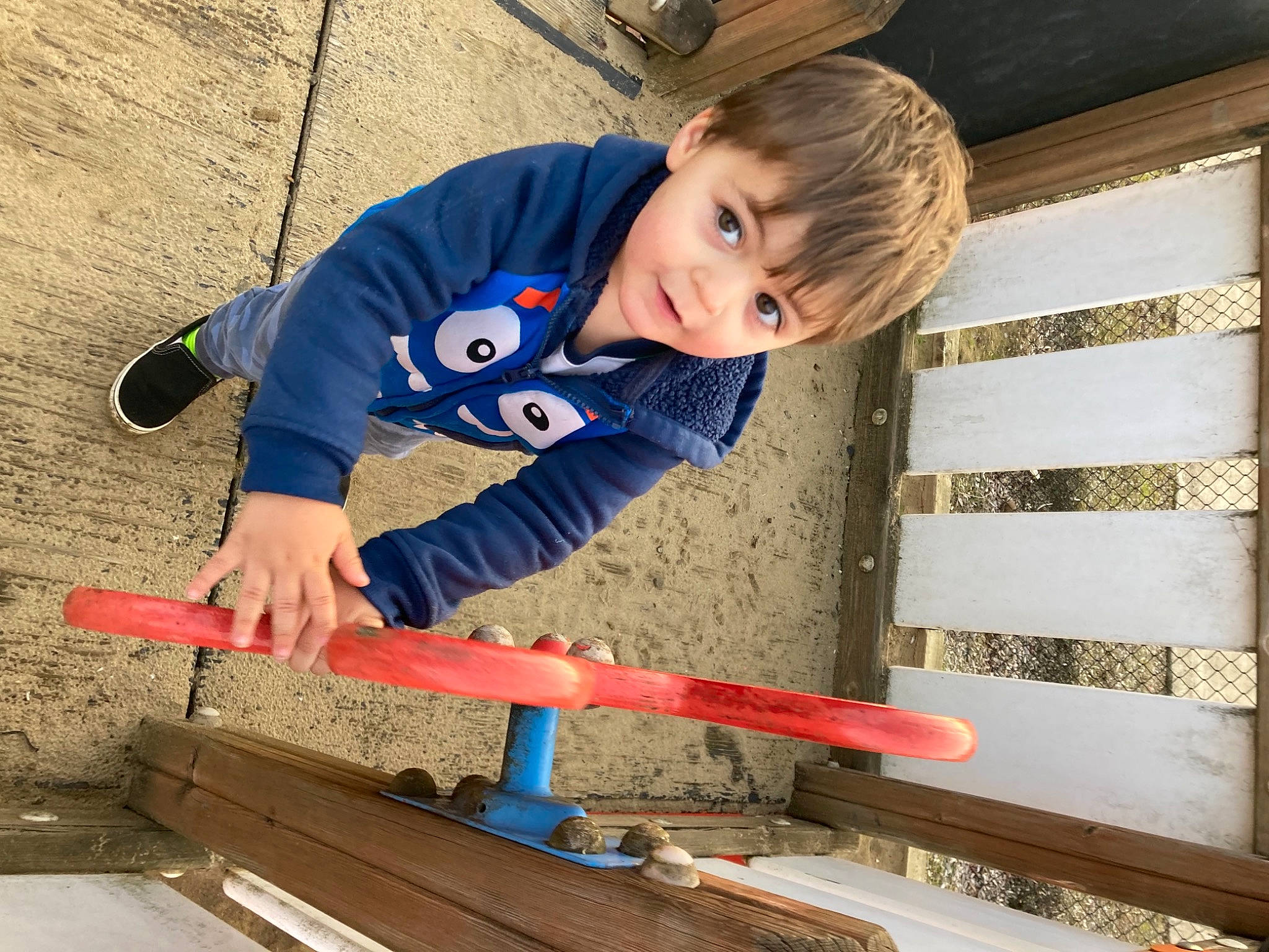 Ethan is registered to the contest to win money with this photo: child, composite_material, concrete, construction_worker, electric_blue, flooring, fun, hardwood, leisure, lumber, person, play, recreation, soil, t_shirt, toddler, tool, tradesman, wood