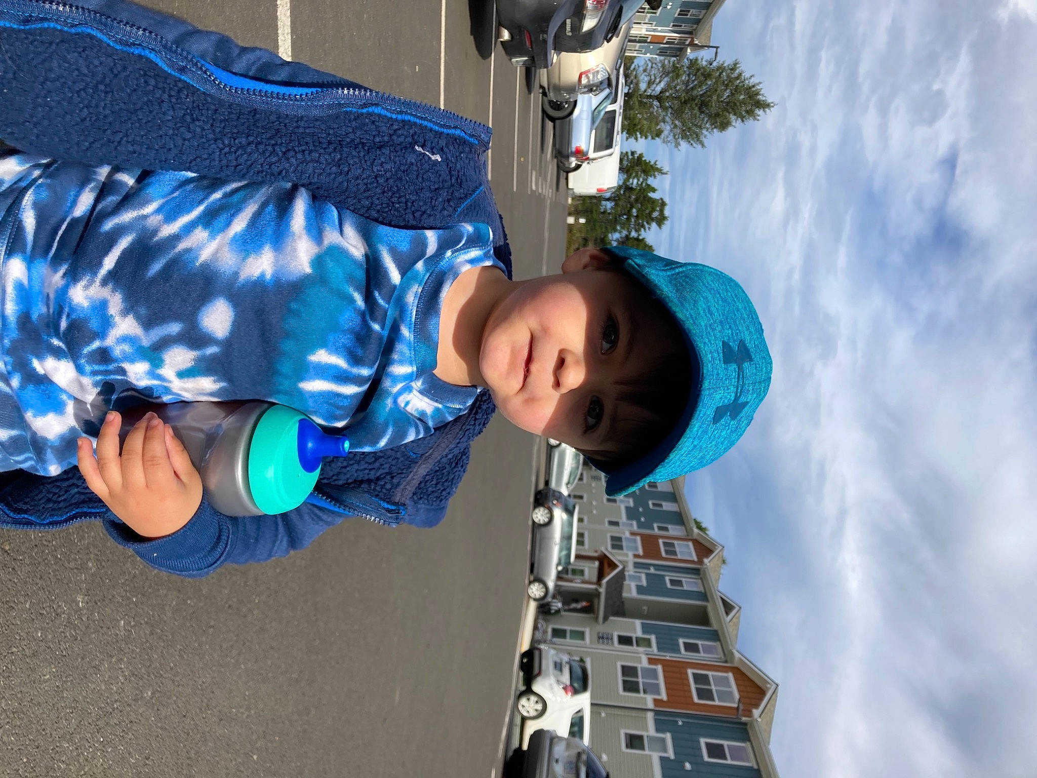 Ethan is registered to the contest to win money with this photo: automotive_exterior, azure, blue, boat, car, child, cloud, daytime, electric_blue, fun, hat, headwear, leisure, person, sky, sleeve, toddler, travel, water, white