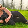 Bobo Da Hobo is registered to the contest to win money with this photo: animal, black_dog, casual, dog, friendship, grass, greenery, happy, leisure, nature, outdoor, pet, pond, portrait, relaxed, resting, smile, summer, sunlight, woman