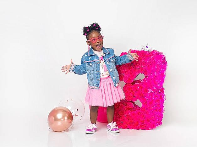 Ariyana joined the competition — help win amazing prizes! ball, balloon, child, costume, event, fashion_design, formal_wear, fun, happy, magenta, party_supply, pattern, person, pink, purple, room, sitting, sleeve, smile, toddler