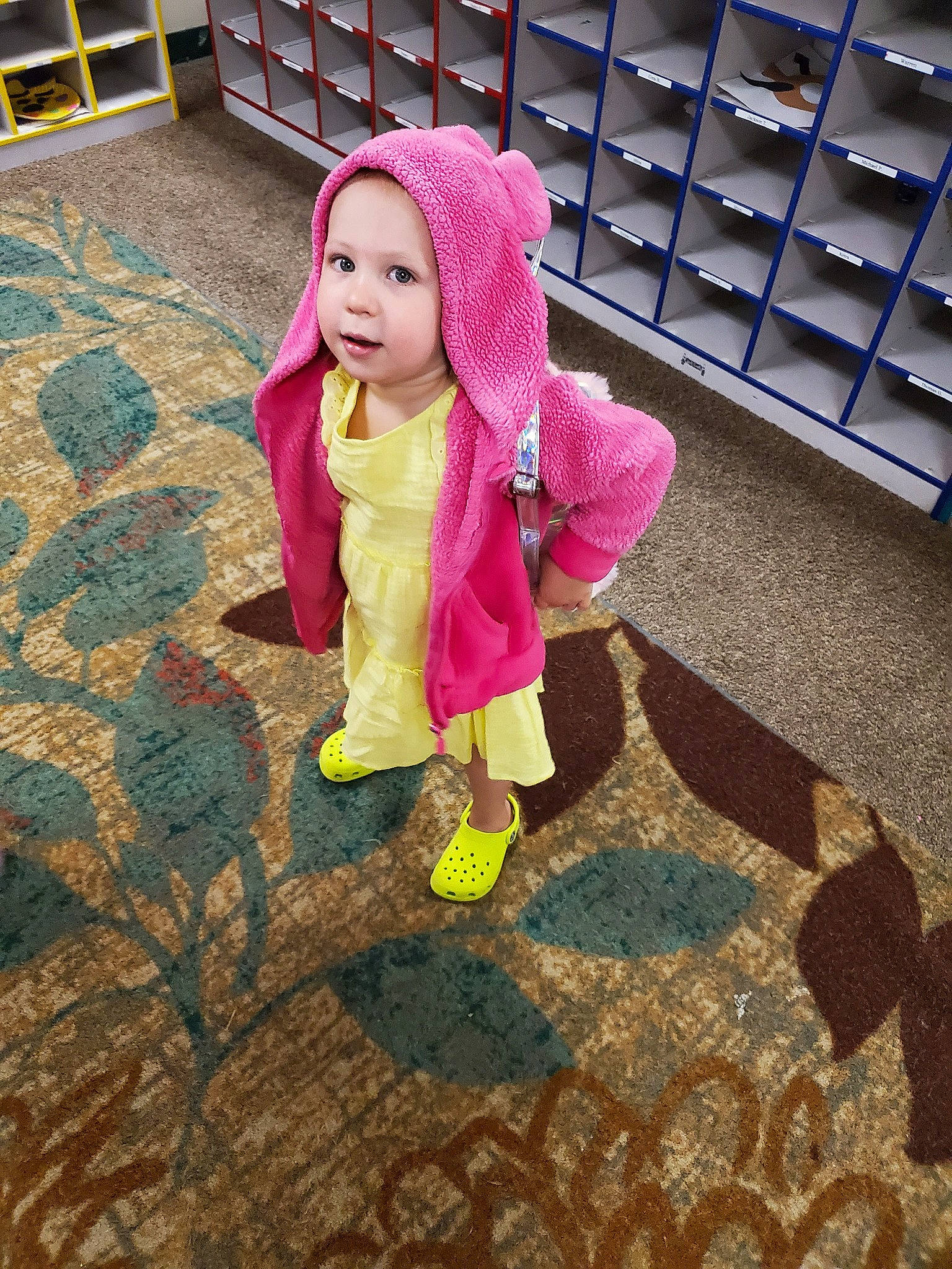 Averi is registered to the contest to win money with this photo: child, costume, floor, flooring, fun, headwear, leisure, outerwear, person, pink, plant, play, skin, smile, snapshot, toddler
