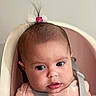 Luna joined the competition — help win amazing prizes! baby, infant, child, face, hair_clip, pink_clothing, baby_seat, harness, curious, close_up, indoor, seat, child_seat, cute, toddler, person, soft_lighting, portrait, young_child, expression