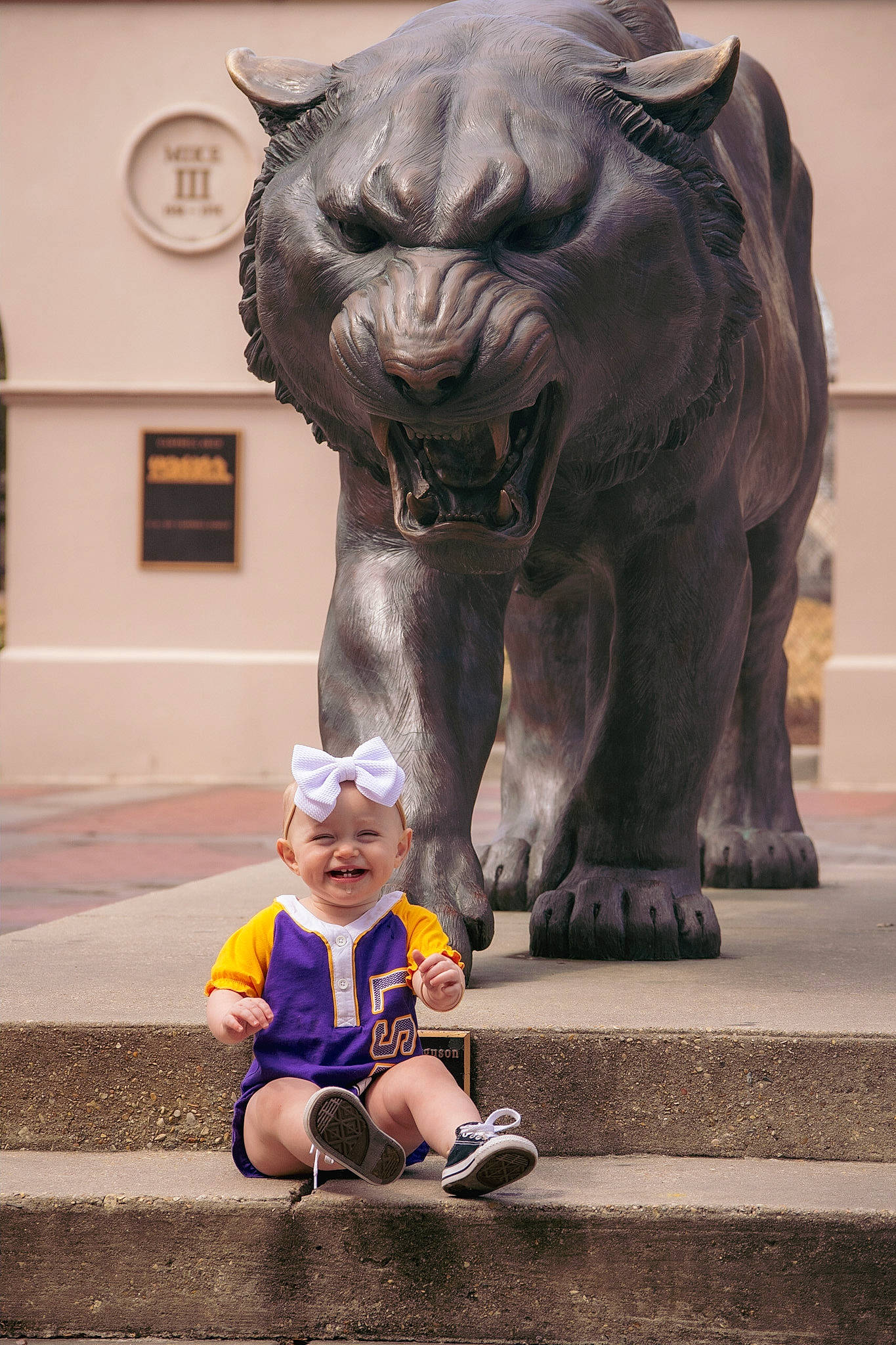 Austyn is registered to the contest to win money with this photo: art, big_cats, carnivore, felidae, happy, headwear, joy, landmark, lion, masai_lion, organ, people, person, photograph, sculpture, smile, snapshot, snout, statue, temple