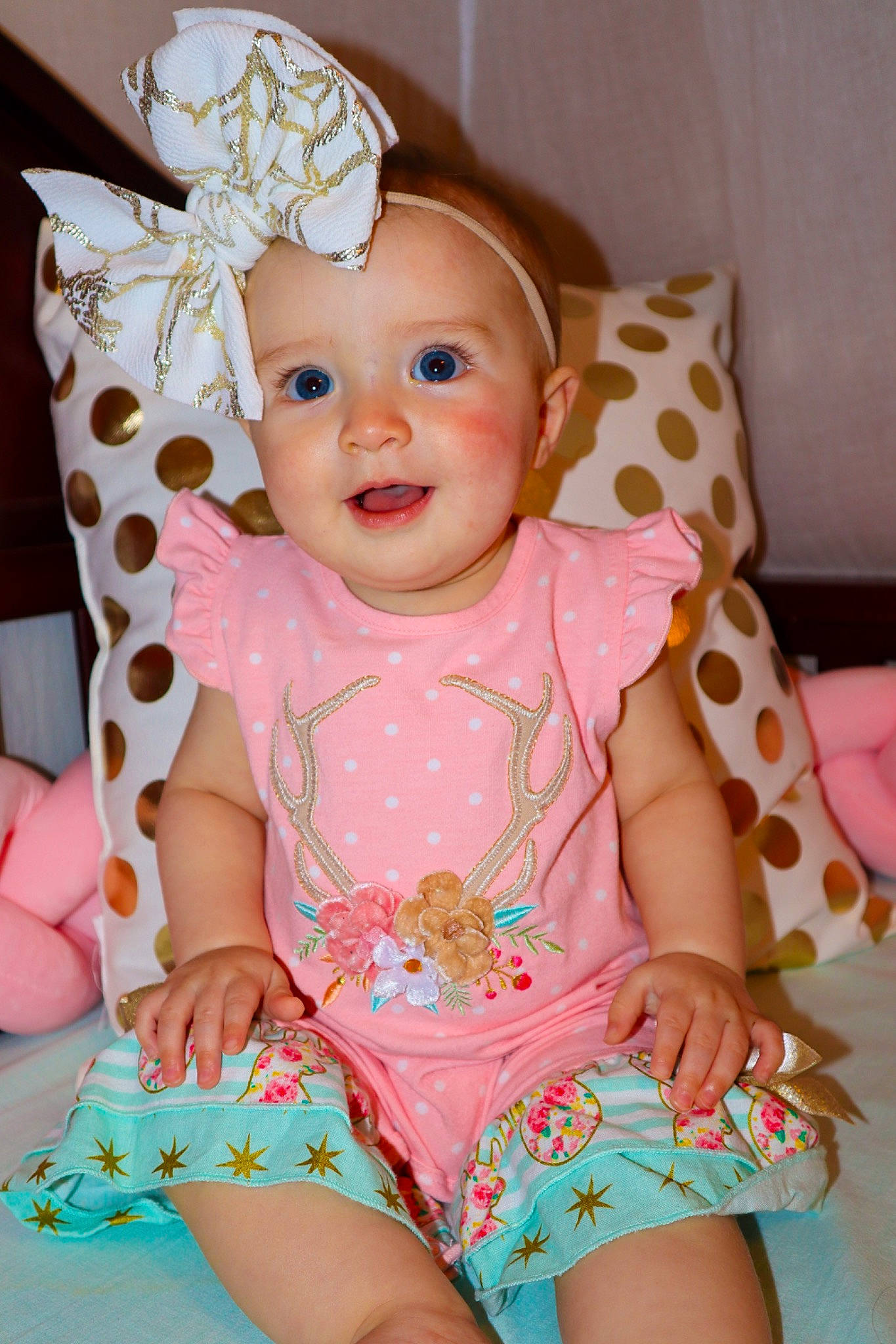 Kaley is registered to the contest to win money with this photo: baby, baby_products, baby_toddler_clothing, child, design, dress, hair_accessory, headgear, headwear, pattern, peach, person, pink, polka_dot, skin, sleeve, smile, textile, toddler