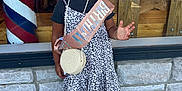 Sienna joined the competition — help win amazing prizes! child, birthday, sash, smile, curly_hair, dress, leopard_print, sandals, sidewalk, stone_wall, window, reflection, car, outdoor, sunny, happy, person, accessory, bag, celebration