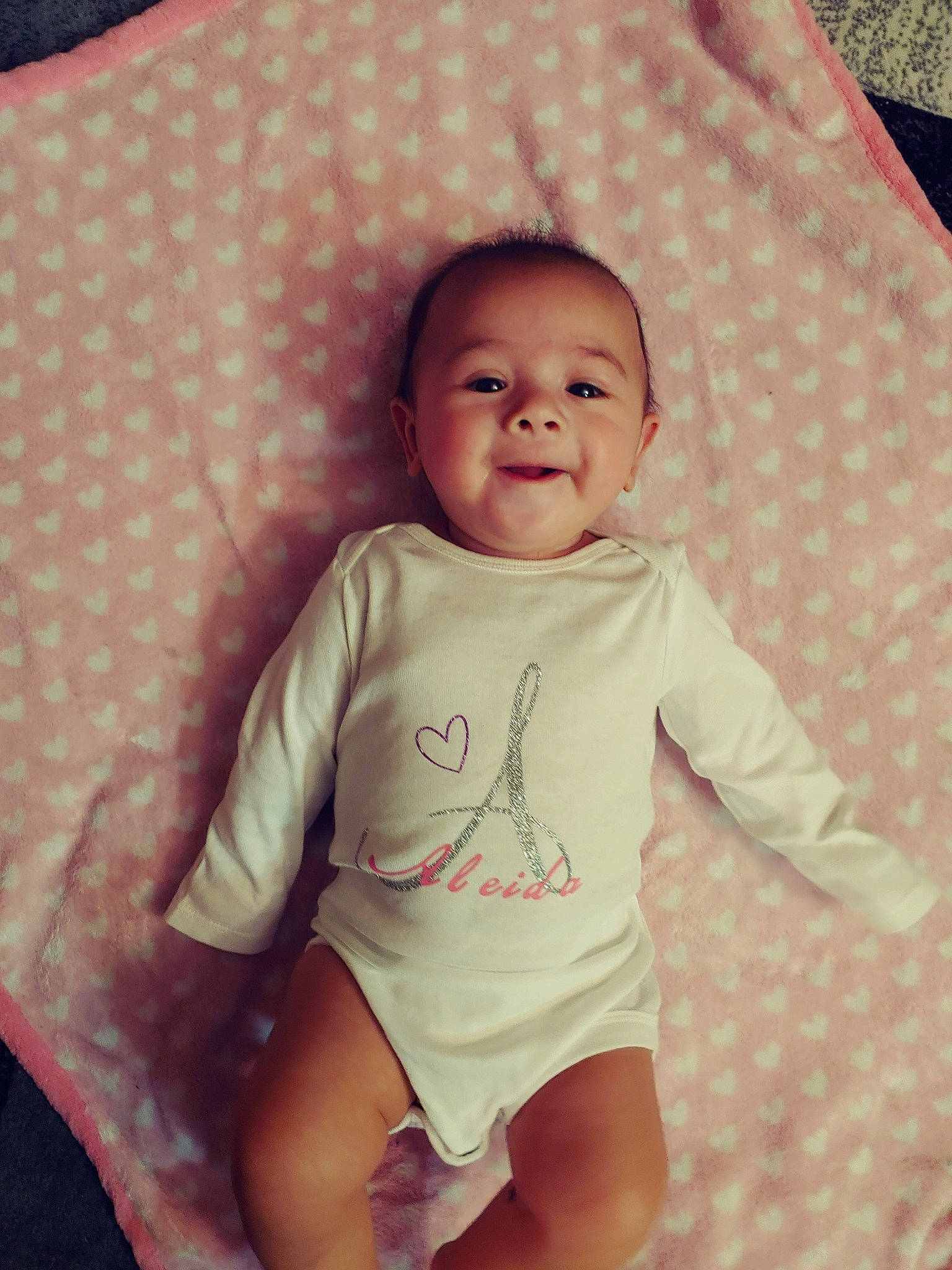 Aleida is registered to the contest to win money with this photo: baby, baby_products, baby_toddler_clothing, cheek, child, comfort, laugh, linens, lip, person, pink, skin, sleeve, toddler