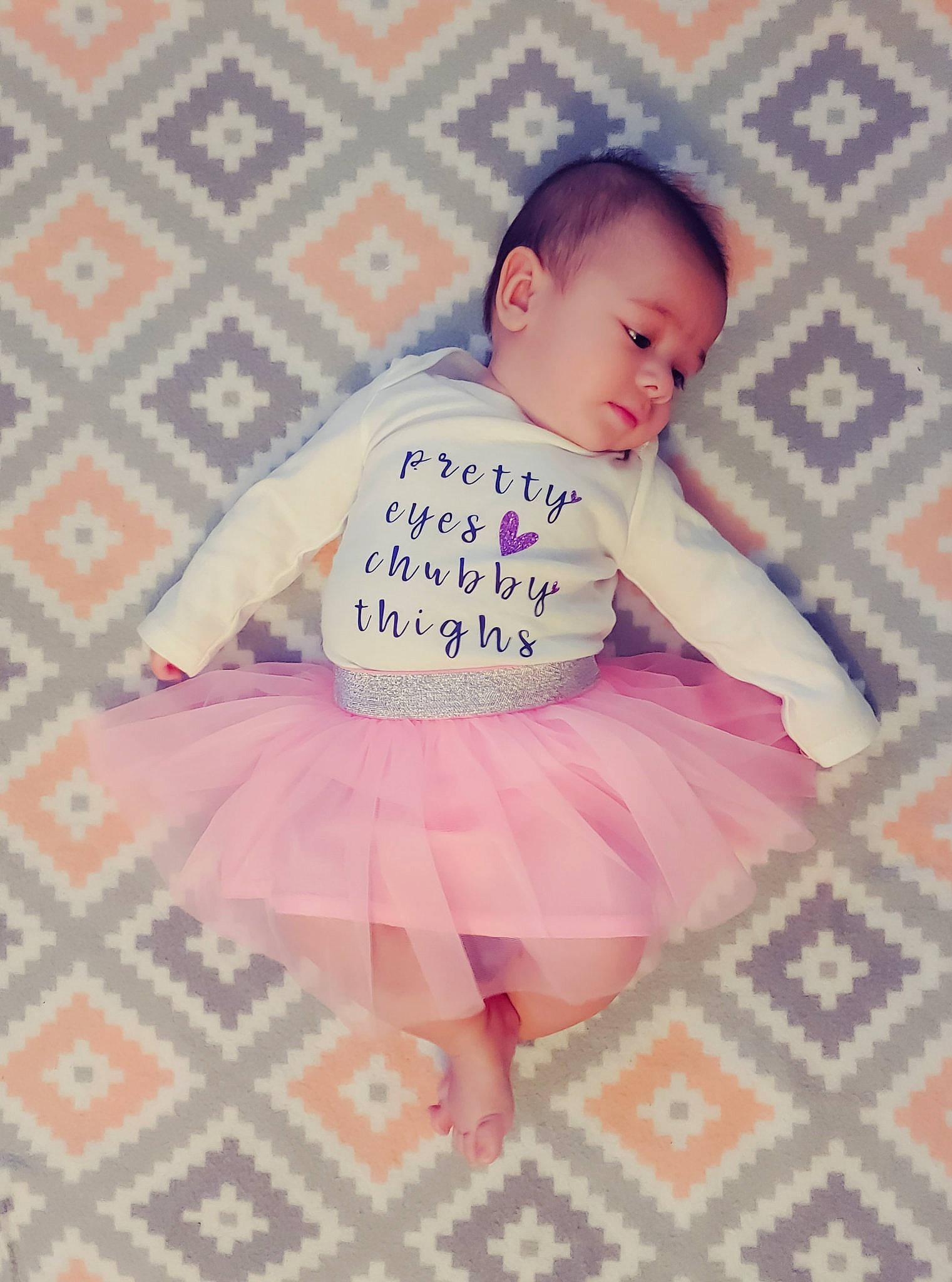 Aleida is registered to the contest to win money with this photo: baby, baby_products, baby_toddler_clothing, ballet_tutu, child, day_dress, design, embellishment, human, lavender, linens, pattern, peach, person, pink, plaid, product, ruffle, textile, toddler