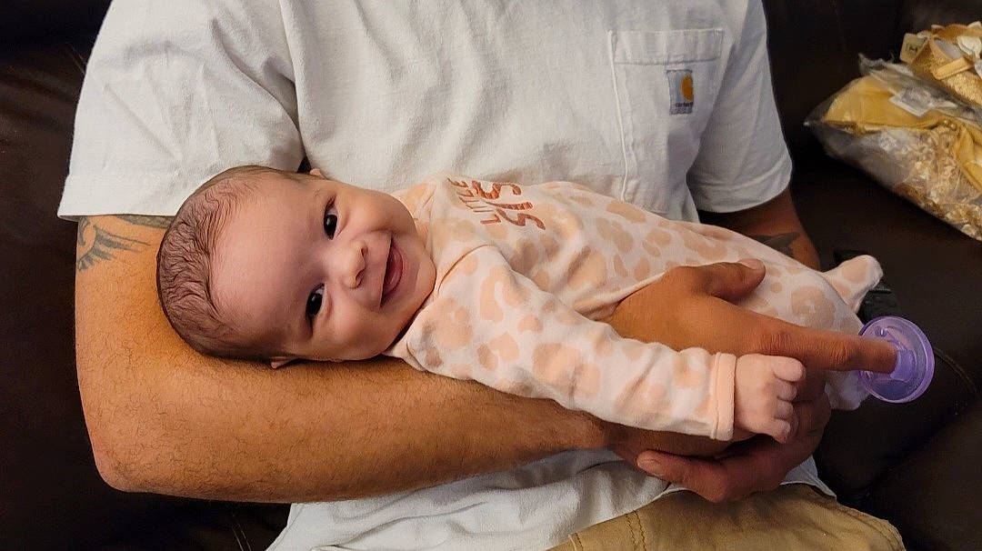 Alayna is registered to the contest to win money with this photo: abdomen, baby, baby_toddler_clothing, child, comfort, elbow, event, flash_photography, happy, joy, mammal, muscle, person, plastic_bag, portrait_photography, room, skin, smile, thumb, toddler