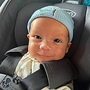 Sebastian joined the competition — help win amazing prizes! baby, infant, car_seat, blue_hat, smile, child, face, seatbelt, clothing, cute, newborn, headwear, straps, safety, portrait, indoors, closeup, person, young, happy