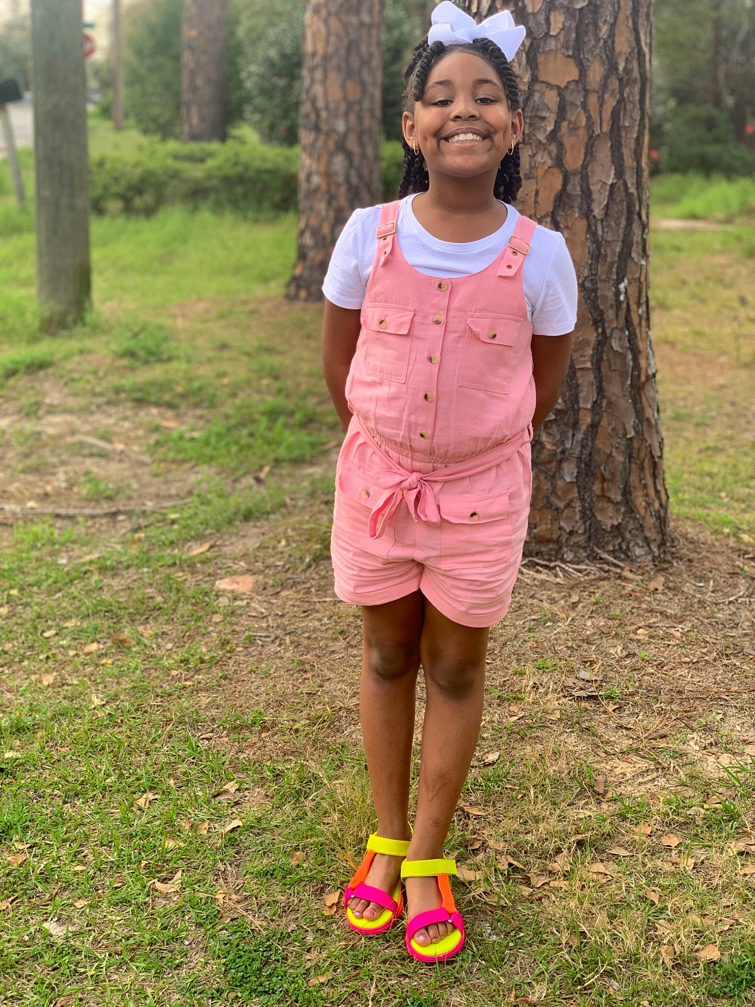 Arrianna is registered to the contest to win money with this photo: child, grass, joy, pattern, person, pink, plant, recreation, shoe, shorts, smile
