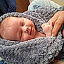 baby, newborn, sleeping, blanket, hand, adult_hand, skin, cozy, soft, wrapped, comfort, peaceful, indoor, closeup, portrait, human, infant, caring, gentle, warmth