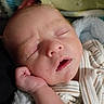Owen is registered to the contest to win money with this photo: baby, sleeping, infant, hand, face, blanket, soft, cozy, cute, newborn, peaceful, closed_eyes, skin, portrait, child, rest, comfort, striped_clothing, indoors, closeup