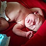 Owen is registered to the contest to win money with this photo: baby, sleeping, diaper, red_blanket, infant, peaceful, skin, lying_down, newborn, face, hand, foot, closeup, soft_texture, nap, resting, domestic, baby_wipes, comfort, cute