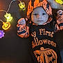 baby, infant, halloween, costume, orange, black, lights, string_lights, pumpkin, ghost, skull, mummy, hand, foot, celebration, holiday, cute, indoors, festive, child