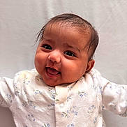 Tara is registered to the contest to win money with this photo: arms_outstretched, baby, cheerful, child, closeup, clothing, cute, expression, eyes, face, happy, head, indoors, infant, mouth, onesie, person, portrait, skin, smiling