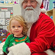 Axton joined the competition — help win amazing prizes! child, santa_claus, holiday, christmas, classroom, festive, beard, red_suit, glasses, smile, blonde_hair, curly_hair, young_child, person, indoor, education, alphabet_cards, decorations, gloves, happy
