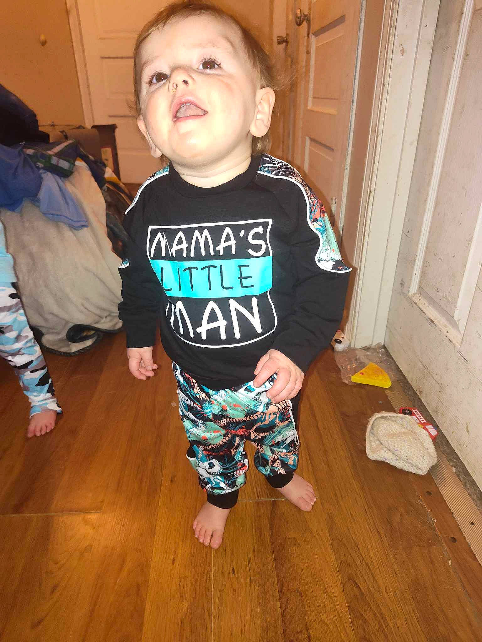 Greysin is registered to the contest to win money with this photo: active_pants, baby_toddler_clothing, cheek, child, door, floor, flooring, happy, hardwood, laminate_flooring, long_sleeved_t_shirt, person, sleeve, smile, t_shirt, thigh, toddler, varnish, wood, wood_flooring