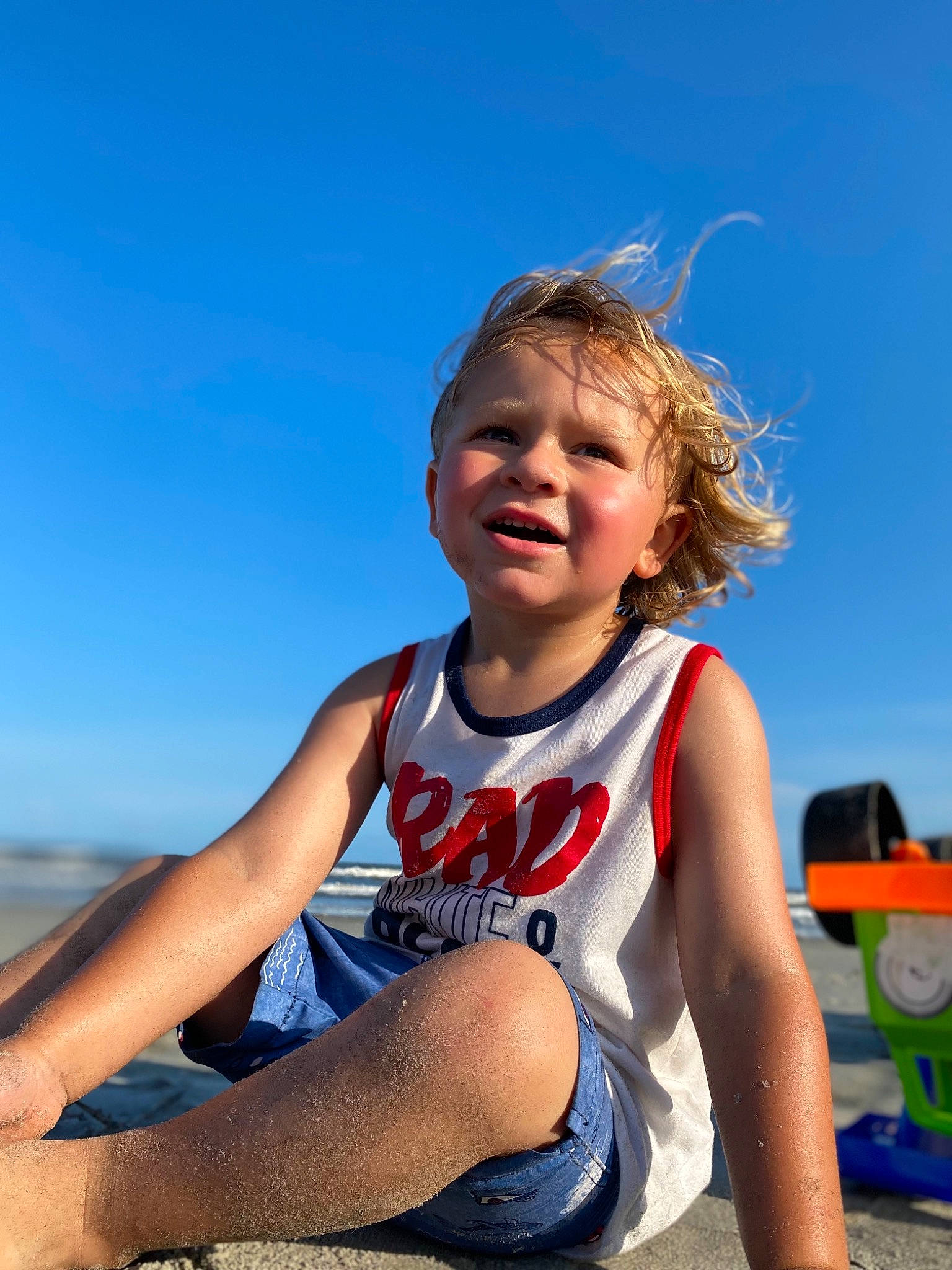 Camdyn is registered to the contest to win money with this photo: barefoot, blond, child, elbow, electric_blue, facial_expression, flash_photography, fun, happy, human_leg, knee, leisure, people_in_nature, person, recreation, sand, sky, sportswear, thigh, toddler