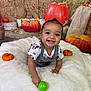 Leilani joined the competition — help win amazing prizes! baby, child, smiling, crawling, toy, green_toy, pumpkin, autumn, fall, hay_bale, blanket, cute, indoor, happy, person, seasonal, orange, decor, portrait, playful