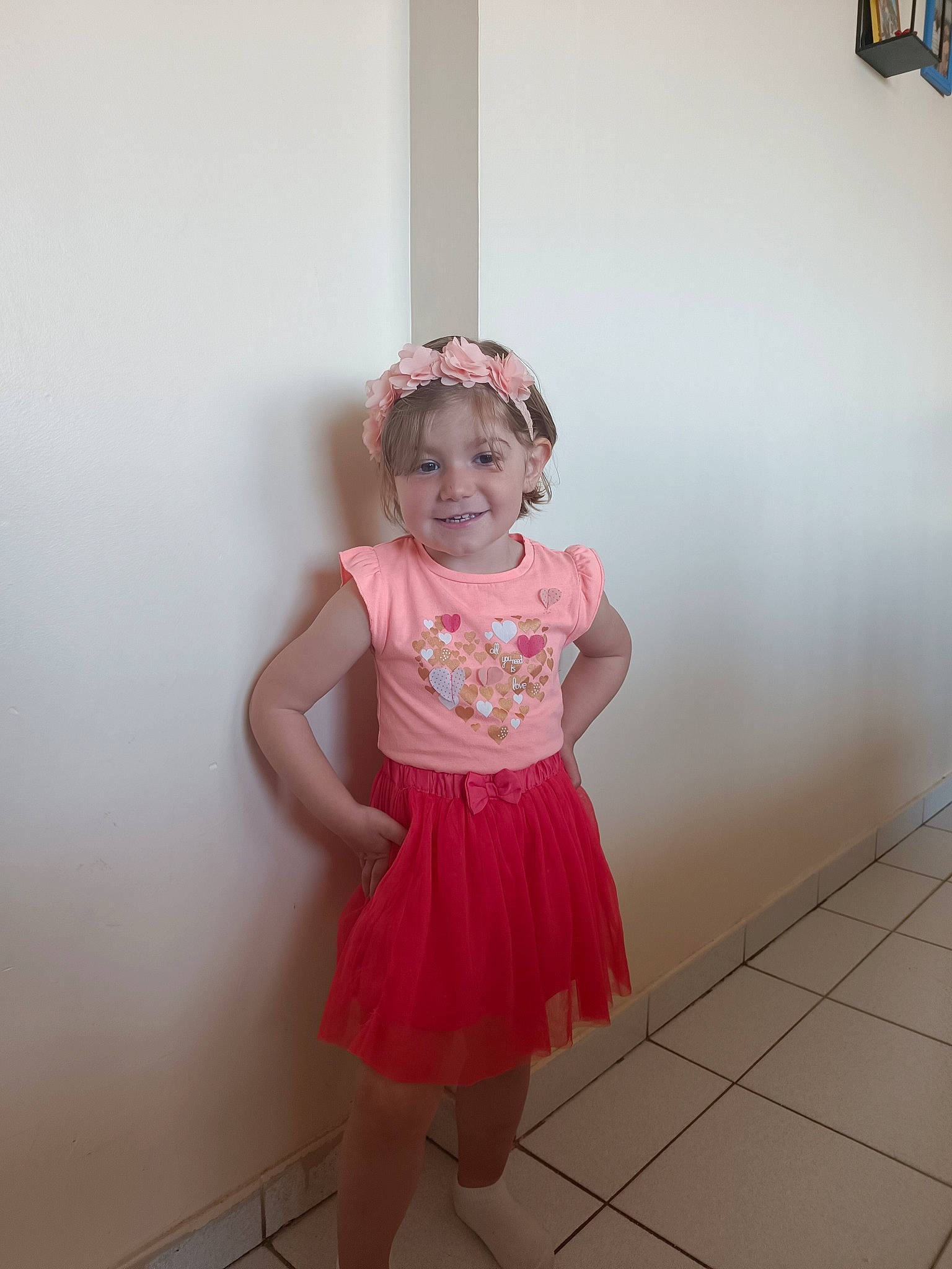 Shana participe au concours pour gagner de l'argent avec cette photo : arm, baby_toddler_clothing, fashion_design, floor, flooring, happy, human_leg, joint, joy, knee, magenta, one_piece_garment, person, pink, room, sleeve, smile, standing, thigh, toddler