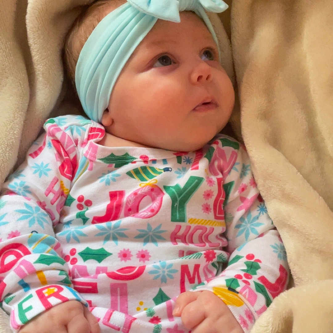 Cora is registered to the contest to win money with this photo: baby, bed, blanket, bodypart, bonnet, clothing, couch, face, finger, furniture, hand, hat, head, newborn, person, photography, portrait, quilt, sleeping, towel