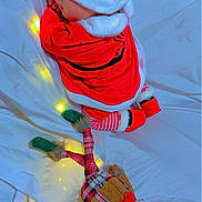 Esraa participe au concours pour gagner de l'argent avec cette photo : baby, bed, child, christmas, cozy, cute, fairy_lights, festive, holiday_theme, indoors, plush_toy, red_clothing, resting, santa_hat, sleeping, soft_lighting, striped_pants, teddy_bear, toy, white_sheet