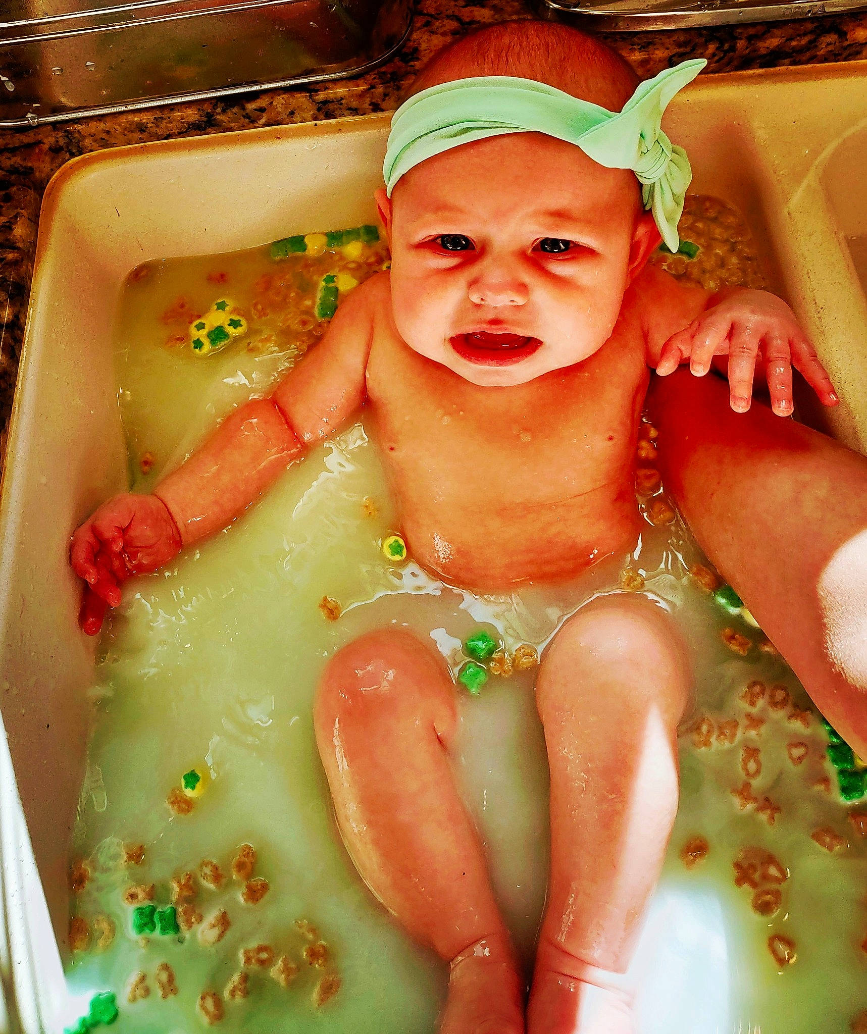 Rosemary is registered to the contest to win money with this photo: baby, baby_bathing, bathing, bathroom, bathtub, cheek, chest, eye, fluid, fun, green, happy, headwear, human_body, leisure, liquid, mouth, person, skin, thumb